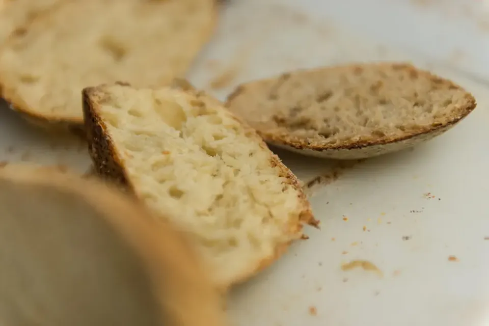 Close-up of slices of sourdough bread showing an open, airy crumb and a thin golden crust
